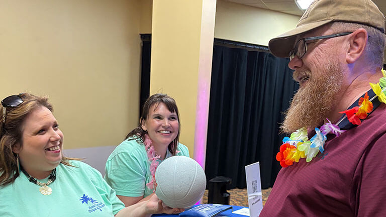 Man receives a basketball at the Ragin’ Beach Bash in Shawnee, Oklahoma.