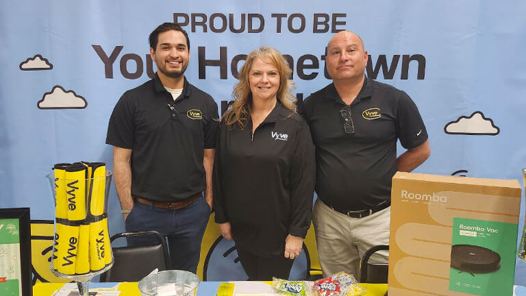 Vyve employees pose for a photo at their Hometown Connection branded booth at the Moses Lake Business Expo.